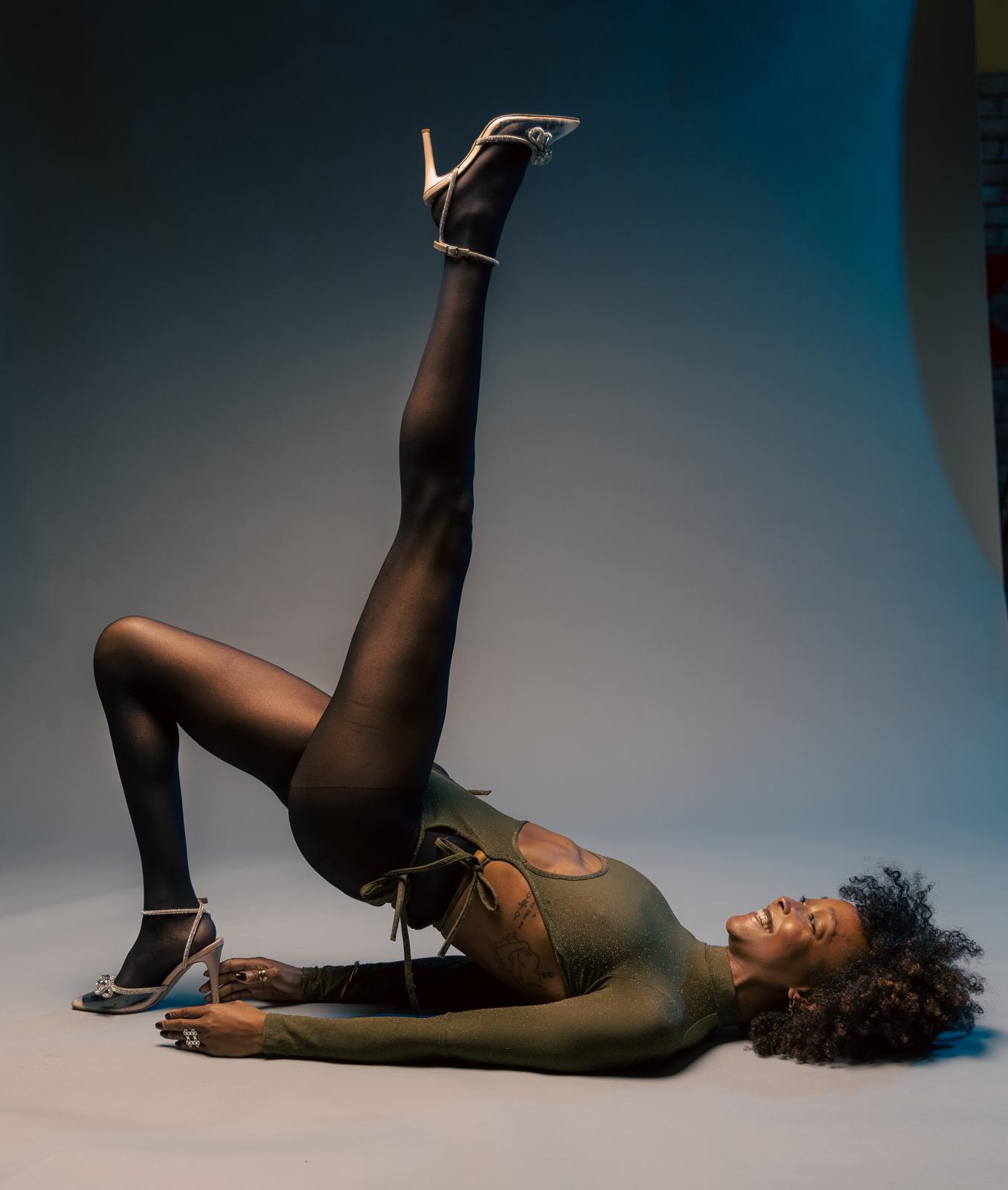Editorial studio portrait, shoulder bridge with one leg lifted