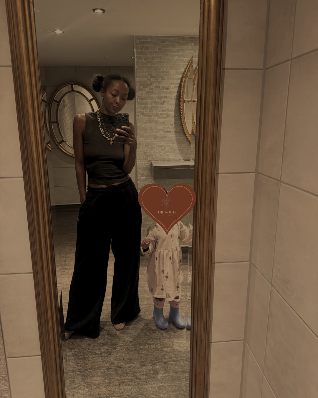 Latesha with her daughter in a mirror